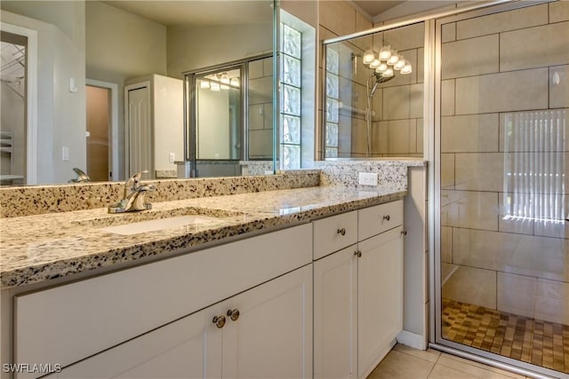 full bathroom with tile patterned floors, a shower stall, vaulted ceiling, and vanity