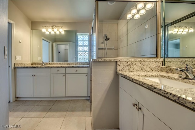 bathroom featuring tile patterned flooring, two vanities, and a sink