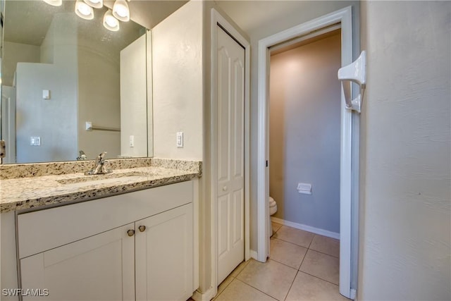 bathroom featuring vanity, toilet, and tile patterned floors