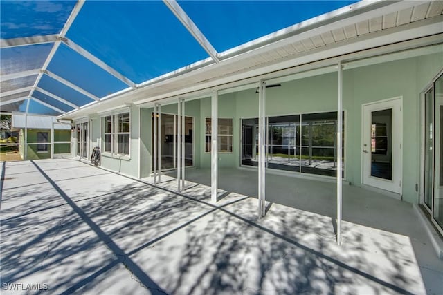 view of patio featuring a lanai