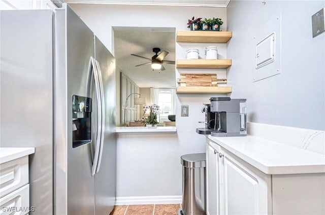 kitchen featuring white cabinets, light countertops, stainless steel refrigerator with ice dispenser, and open shelves