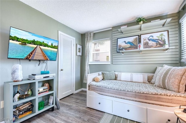 bedroom featuring a textured ceiling and wood finished floors