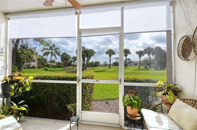 sunroom / solarium with plenty of natural light and ceiling fan