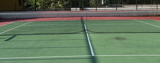 view of sport court featuring fence