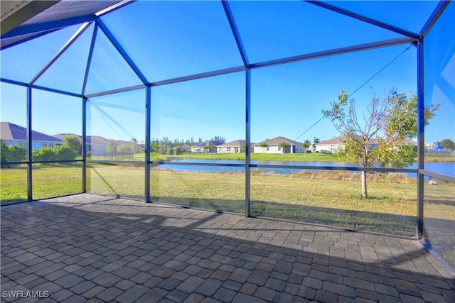 unfurnished sunroom with a water view