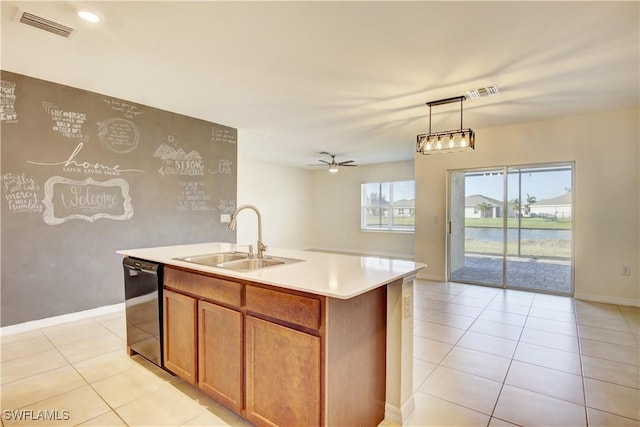 kitchen featuring dishwasher, light countertops, a sink, and visible vents