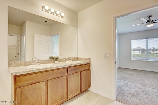 bathroom featuring double vanity, tile patterned flooring, ceiling fan, and a sink