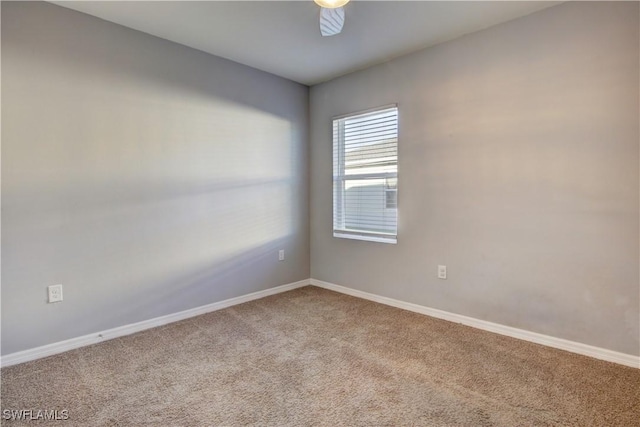 spare room featuring a ceiling fan, carpet flooring, and baseboards