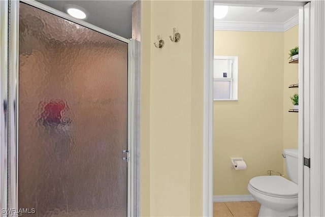 full bathroom featuring toilet, visible vents, ornamental molding, tile patterned floors, and a stall shower