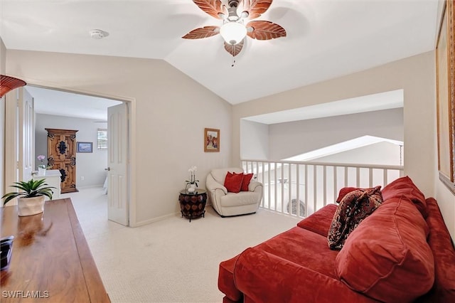 living area featuring lofted ceiling, ceiling fan, baseboards, and carpet flooring