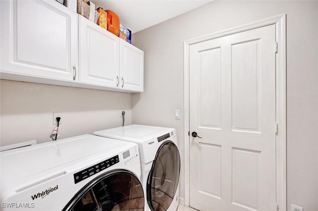 washroom with washing machine and dryer and cabinet space