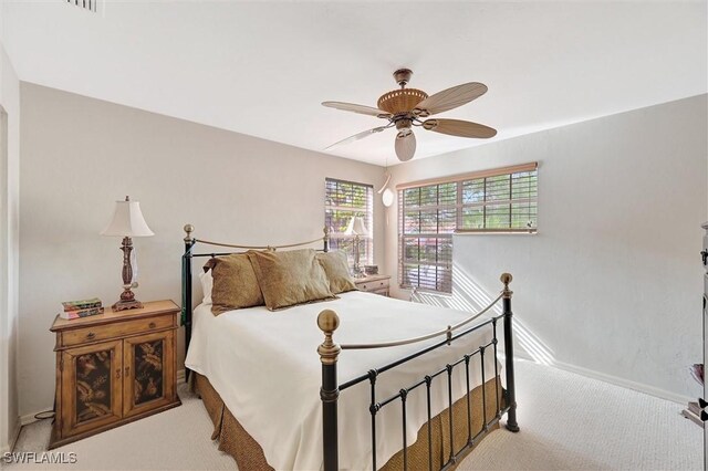 carpeted bedroom featuring baseboards and ceiling fan