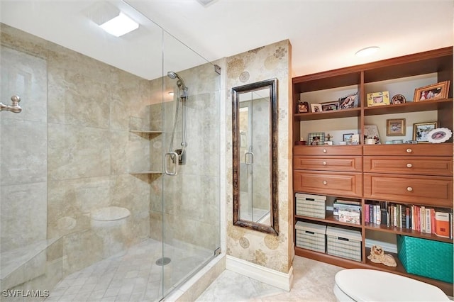 full bathroom with toilet, a shower stall, baseboards, and tile patterned floors