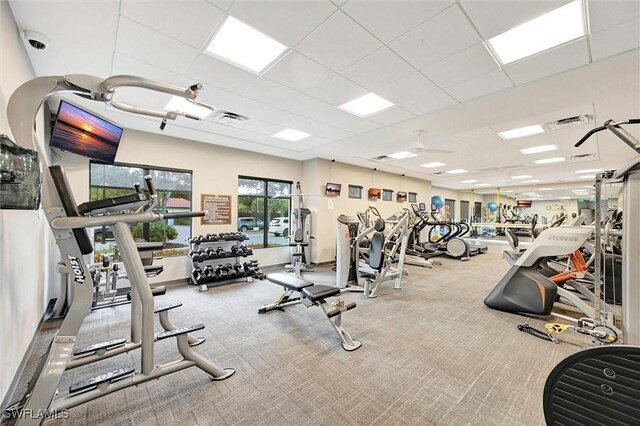 workout area with ceiling fan and carpet flooring