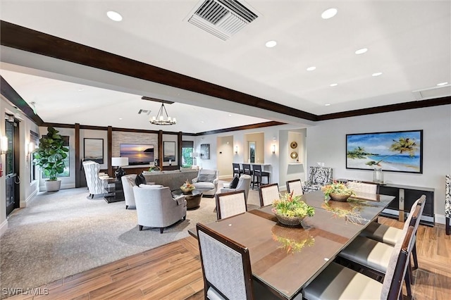 dining room featuring vaulted ceiling with beams, light wood-style flooring, recessed lighting, visible vents, and crown molding