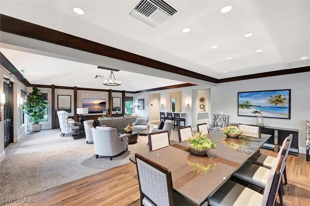 dining space featuring light wood-style flooring, baseboards, recessed lighting, crown molding, and a chandelier