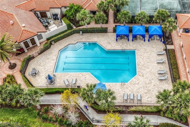 pool featuring fence and a patio