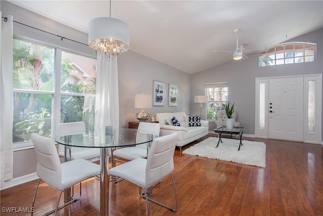 dining area featuring baseboards, lofted ceiling, and hardwood / wood-style floors