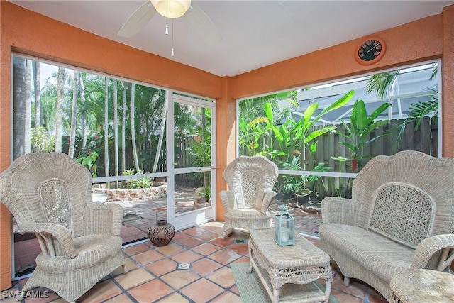 sunroom / solarium featuring a ceiling fan