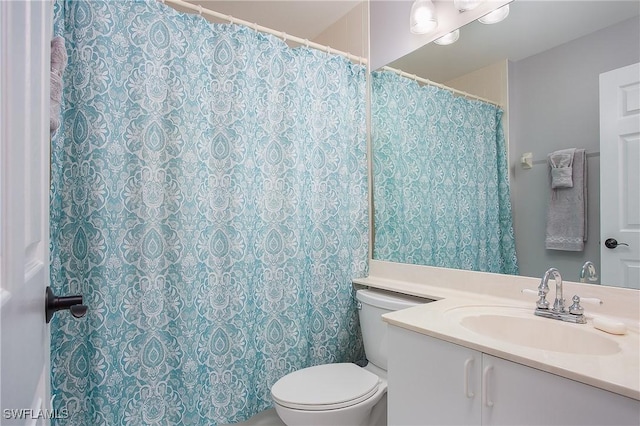 full bathroom featuring toilet and vanity