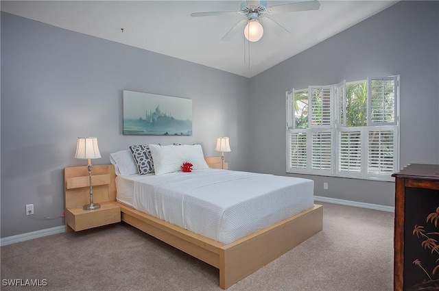 carpeted bedroom with baseboards, lofted ceiling, and a ceiling fan