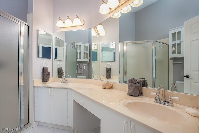 full bathroom with a shower stall, double vanity, and a sink