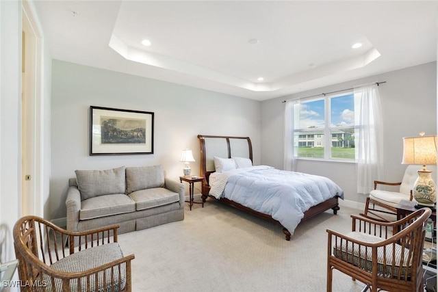 bedroom with recessed lighting, a raised ceiling, baseboards, and carpet floors