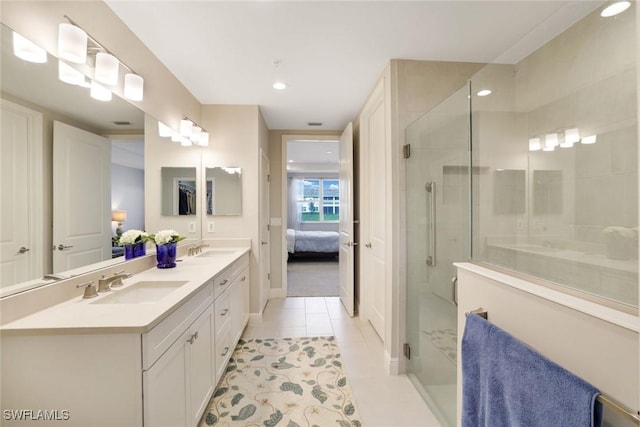 bathroom with a sink, connected bathroom, double vanity, and a shower stall