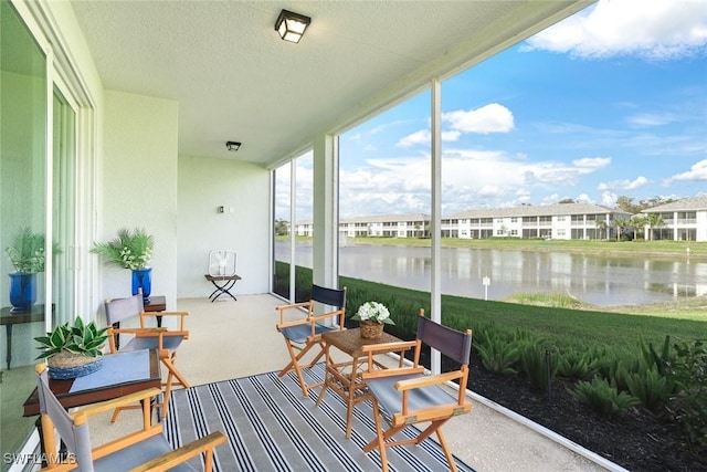 sunroom / solarium featuring a water view