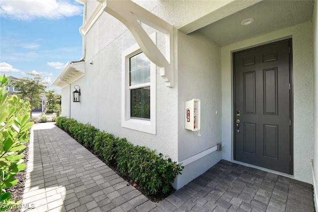 property entrance featuring stucco siding