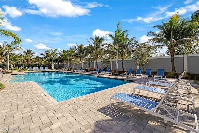 community pool featuring a patio area and fence