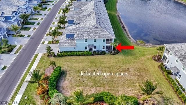 birds eye view of property with a water view