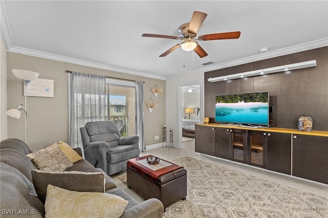 living room featuring visible vents, baseboards, ceiling fan, and ornamental molding