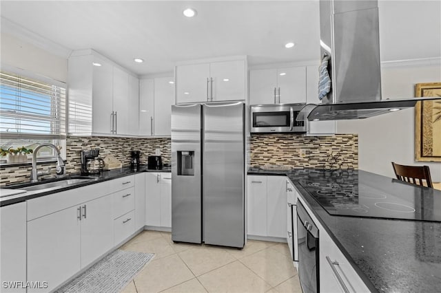 kitchen featuring range hood, a sink, appliances with stainless steel finishes, white cabinetry, and crown molding