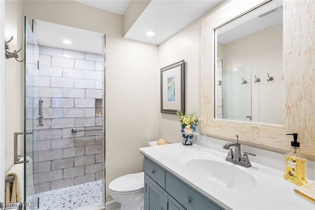 full bathroom featuring toilet, a shower stall, and vanity