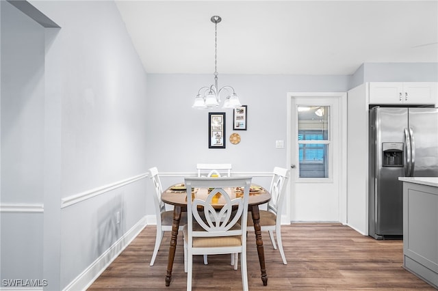 dining room featuring a notable chandelier and wood finished floors