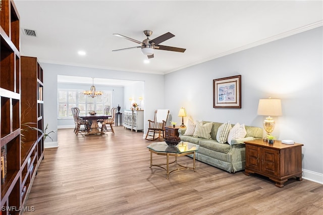 living room featuring crown molding, visible vents, and wood finished floors