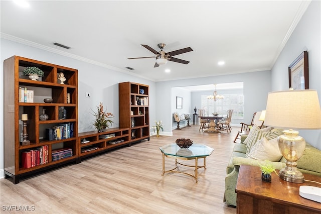 living area with crown molding, visible vents, wood finished floors, and ceiling fan with notable chandelier