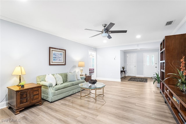 living area featuring crown molding, visible vents, light wood-style floors, ceiling fan, and baseboards