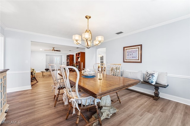 dining room with baseboards, ornamental molding, and light wood-style floors