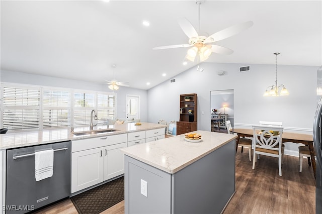 kitchen featuring visible vents, wood finished floors, a center island, stainless steel appliances, and a sink