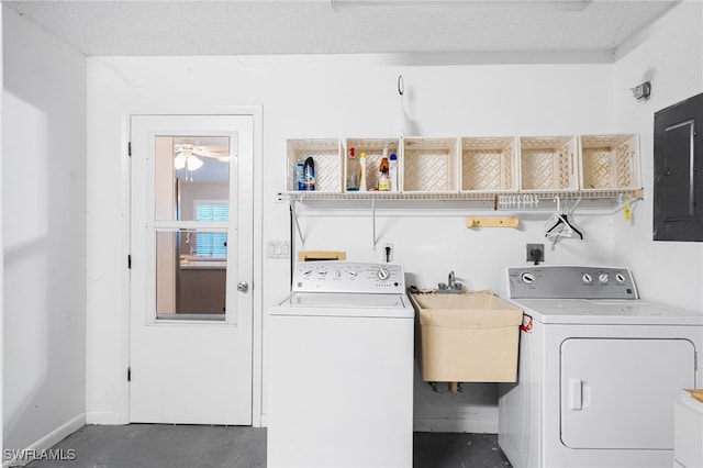 laundry area featuring washer and dryer, laundry area, electric panel, and a sink