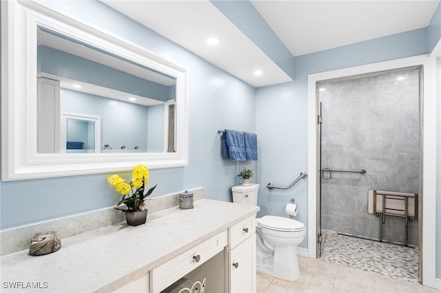 bathroom featuring recessed lighting, toilet, a tile shower, vanity, and tile patterned floors