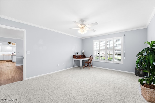 office space with light carpet, ceiling fan, ornamental molding, and baseboards