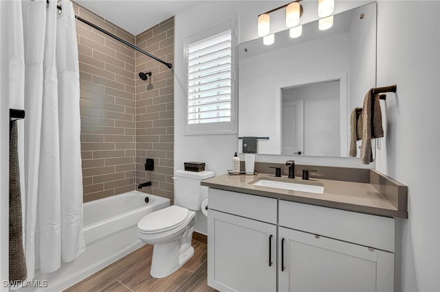 full bathroom featuring toilet, shower / bath combo, wood finished floors, and vanity