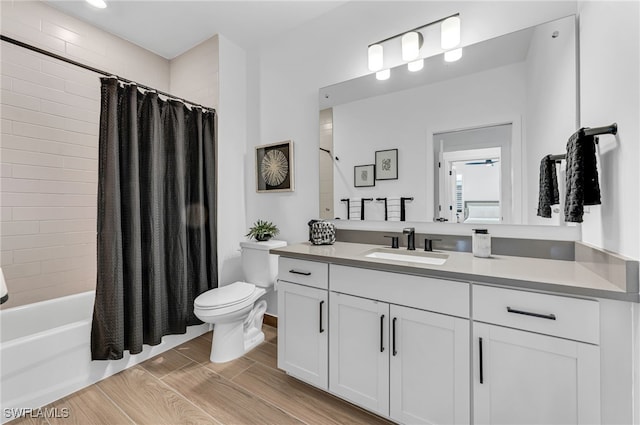 full bath with shower / bath combo with shower curtain, vanity, toilet, and wood tiled floor