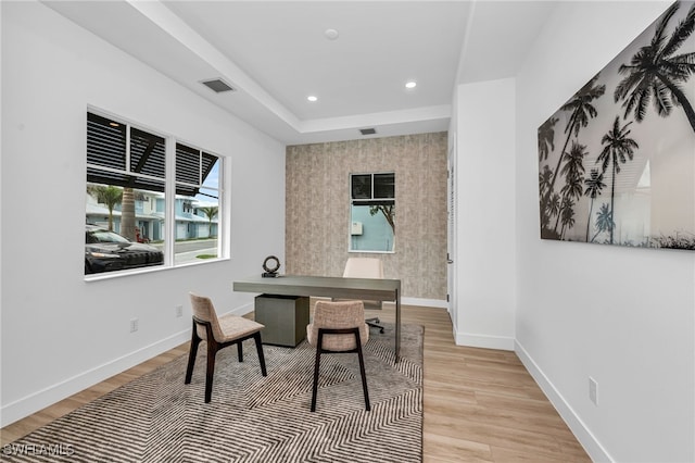 home office with recessed lighting, visible vents, light wood-style flooring, and baseboards