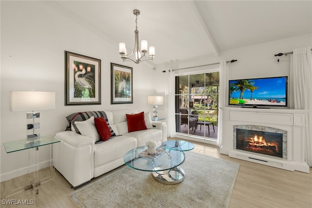 living area featuring a chandelier, vaulted ceiling with beams, wood finished floors, and a fireplace