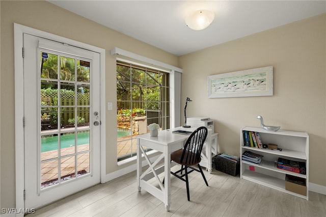 home office featuring baseboards and wood finished floors