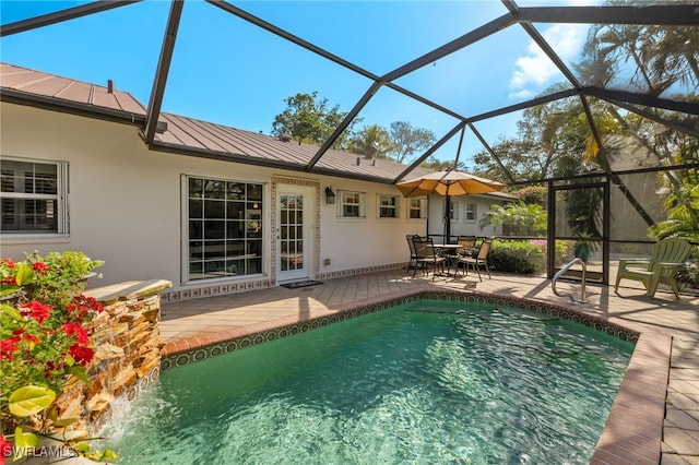 view of pool with outdoor dining space, a patio, and a lanai